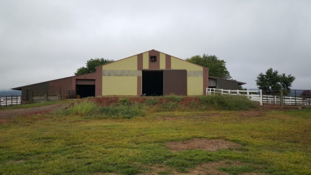 Looking at the back of the indoor arena and stall area